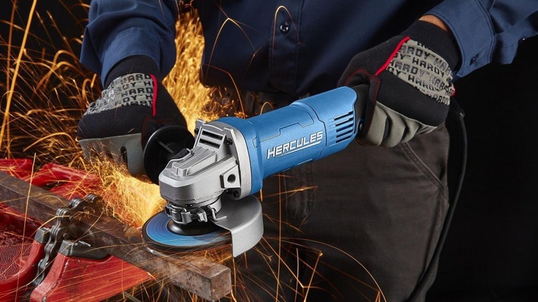 A person using a Hercules angle grinder with sparks shooting from it