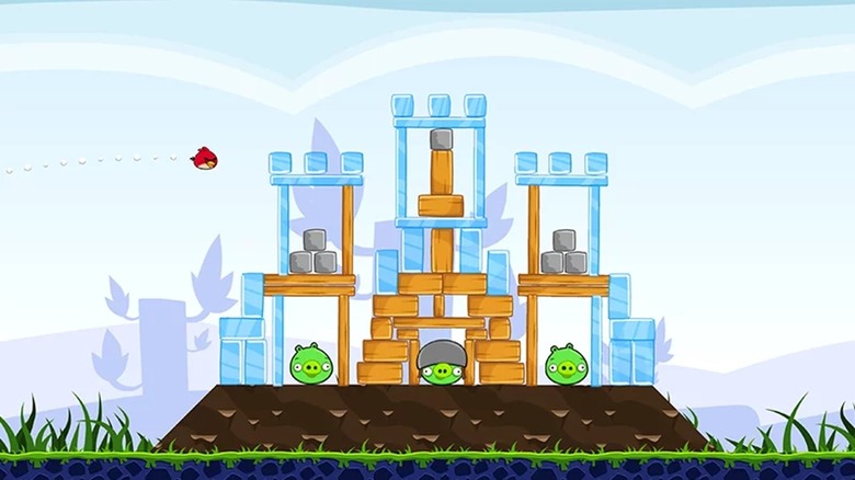 Red flying into the pigs' fortress in "Rovio Classics: Angry Birds."