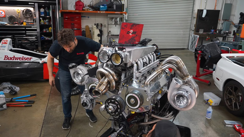 Rob Dahm with his 12-rotor engine on mount in workshop