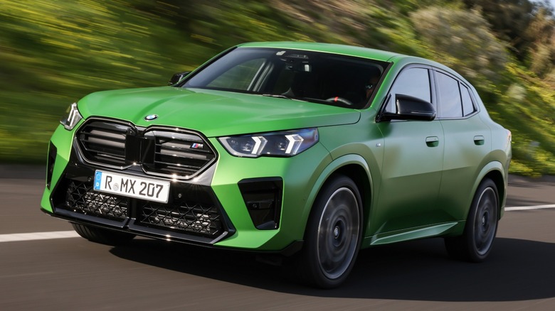 a green BMW X2 M35i driving on the road