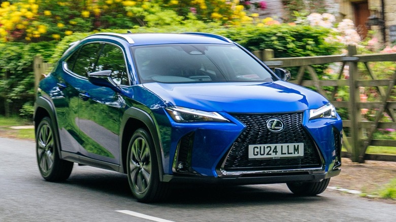 a blue Lexus UX driving on the road