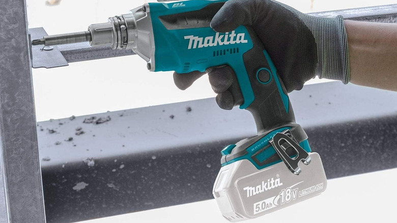 person using makita drywall screwdriver