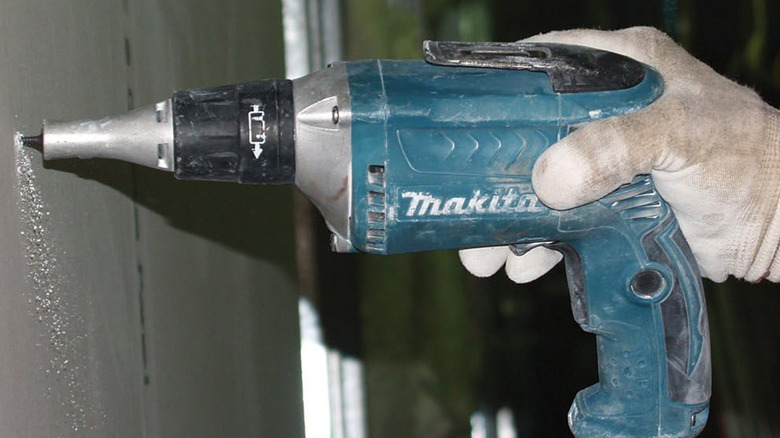 person using makita drywall screwdriver