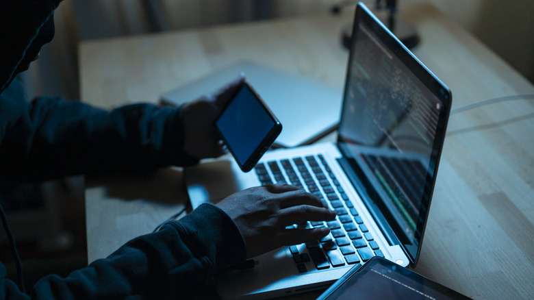 shadowy person on computer