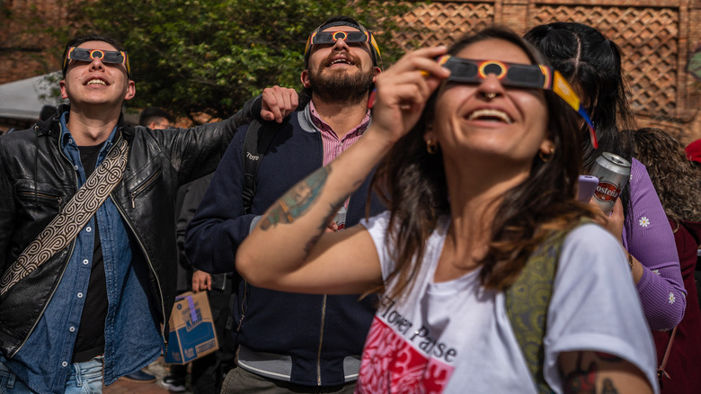 People viewing solar eclipse wearing special glasses