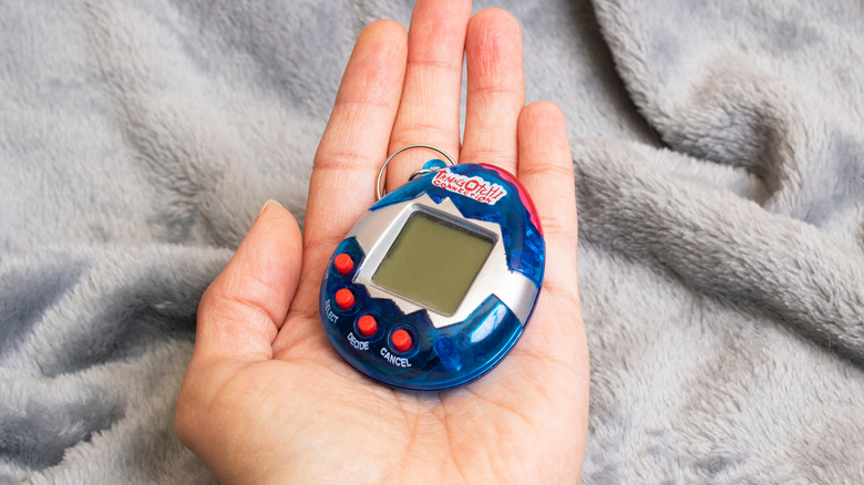 Blue Tamagotchi in hand