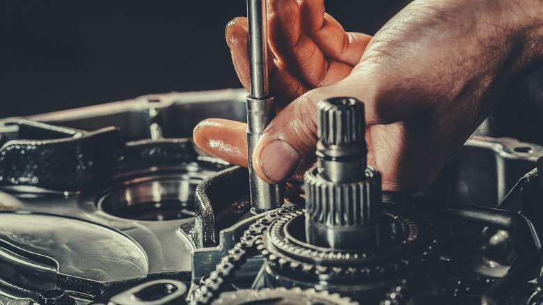 Mechanic working on vehicle transmission