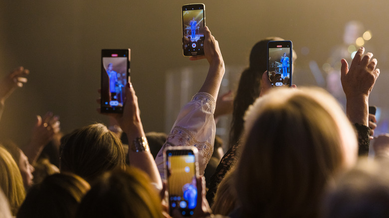 People recording concert with phones