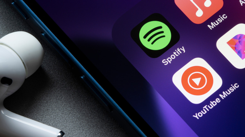 smartphone showing spotify and youtube music icons