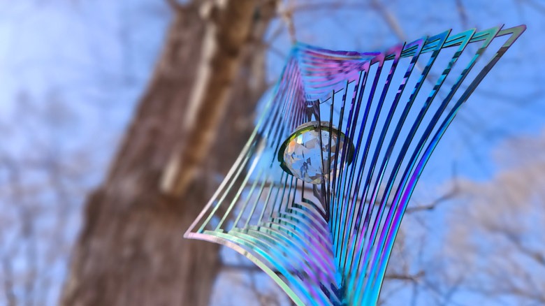 Wind chime with glass ball hung from tree