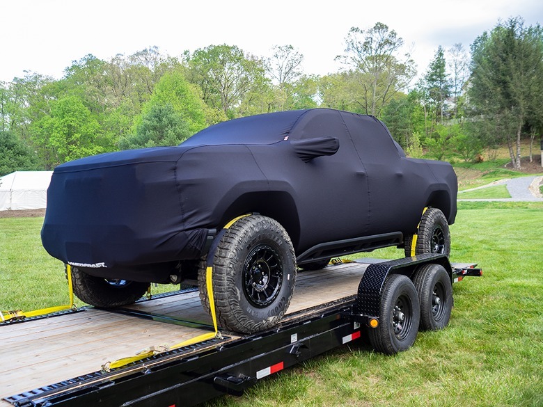 Mystery GMC AT4X truck strapped down on a flatbed trailer